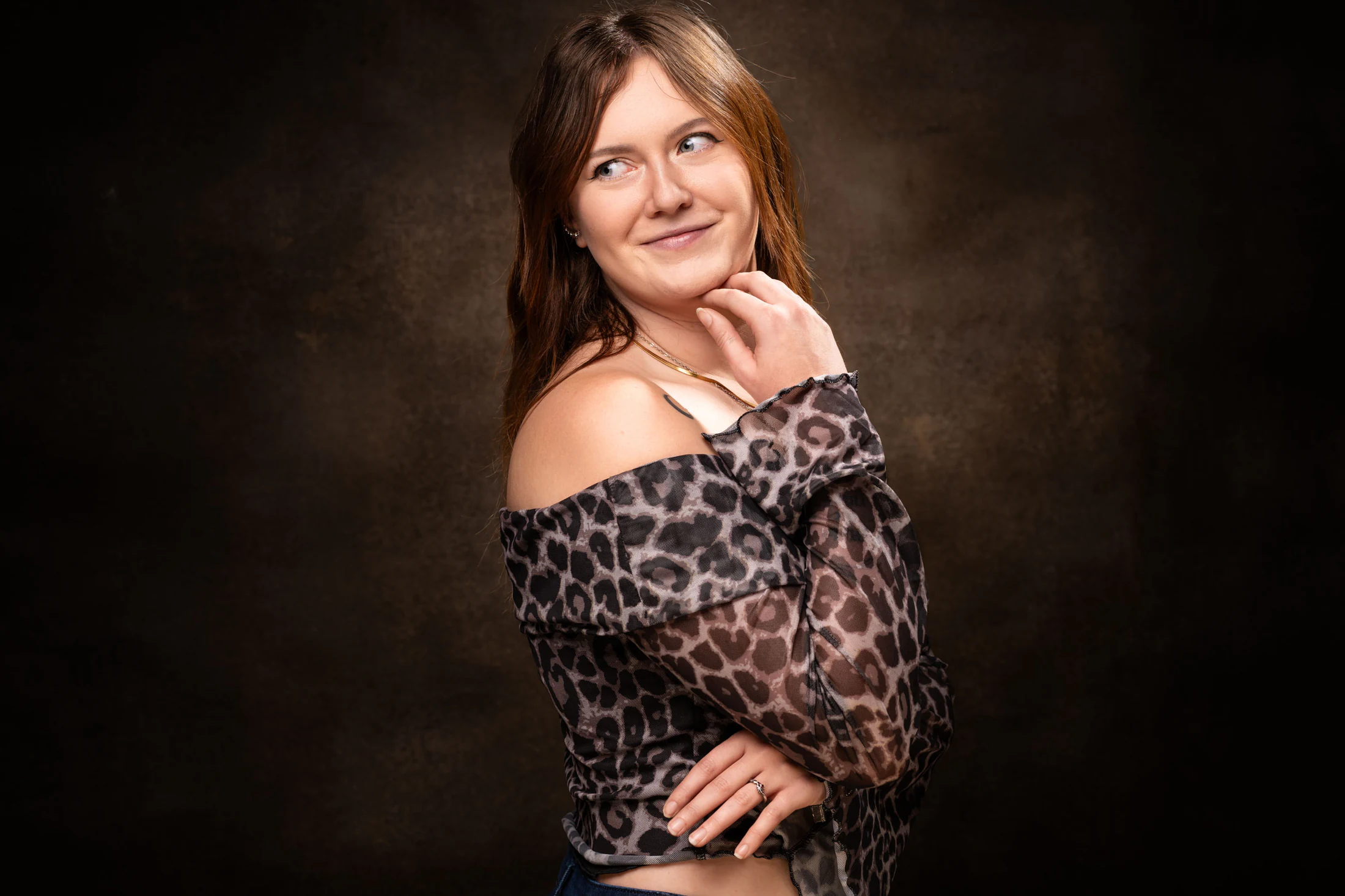 Portrait de femme souriante sur fond brun au studio
